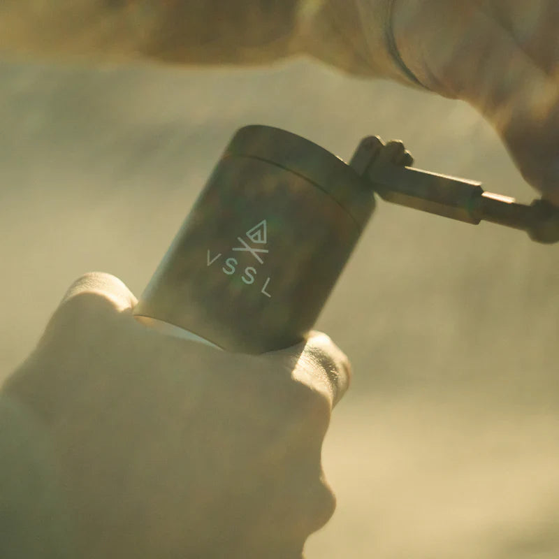 Person using a VSSL coffee grinder 